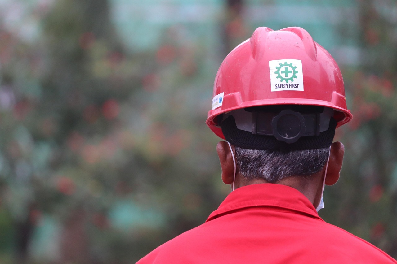 A worn hard hat being inspected